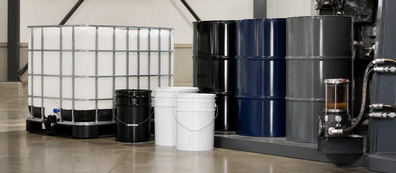 Sealed lubricant formats beside industrial hydraulic fittings.